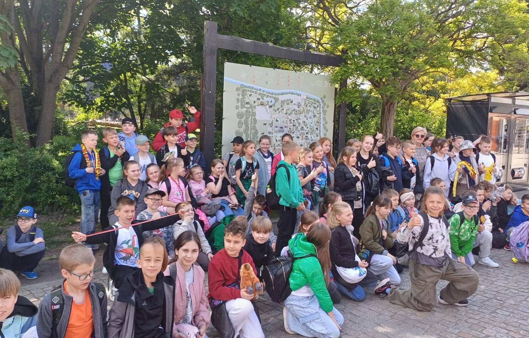 Na zdjęciu grupa dzieci podczas wycieczki w otoczeniu przyrody